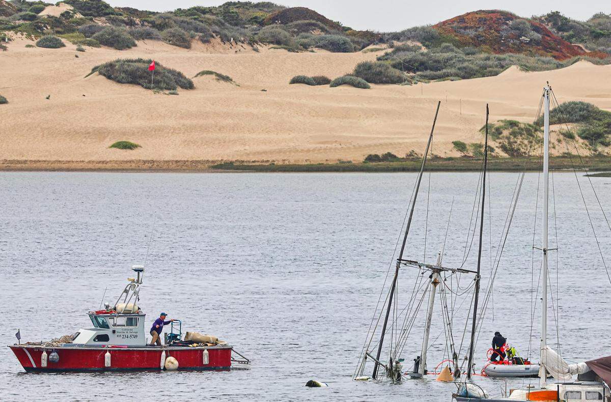 The fishing boat Lady Maxine is seen partially submerged in the Morro Bay Harbor.