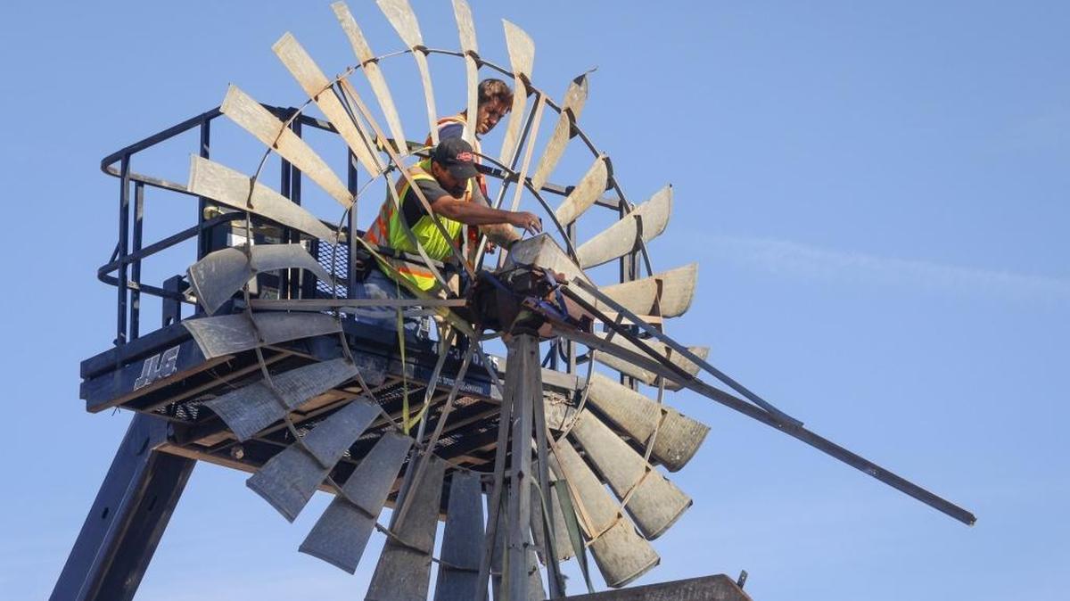 Workers dismantle the windmill at Bonetti Ranch as site work progresses on the property that will become the SLO Public Market.