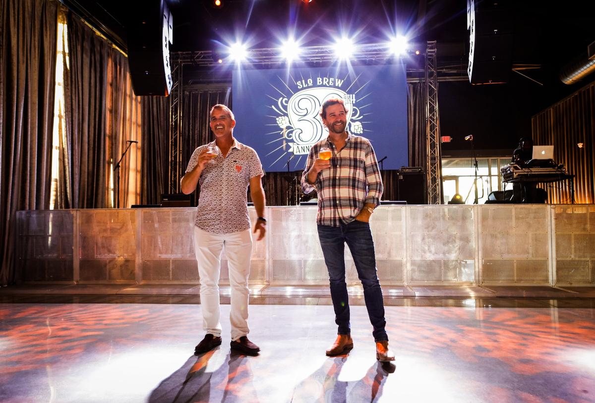 Co-owners Rodney Cegelski, left, and Hamish Marshall celebrate SLO Brew’s SLO Brew Rock opening in 2017 near the San Luis Obispo County Regional Airport.