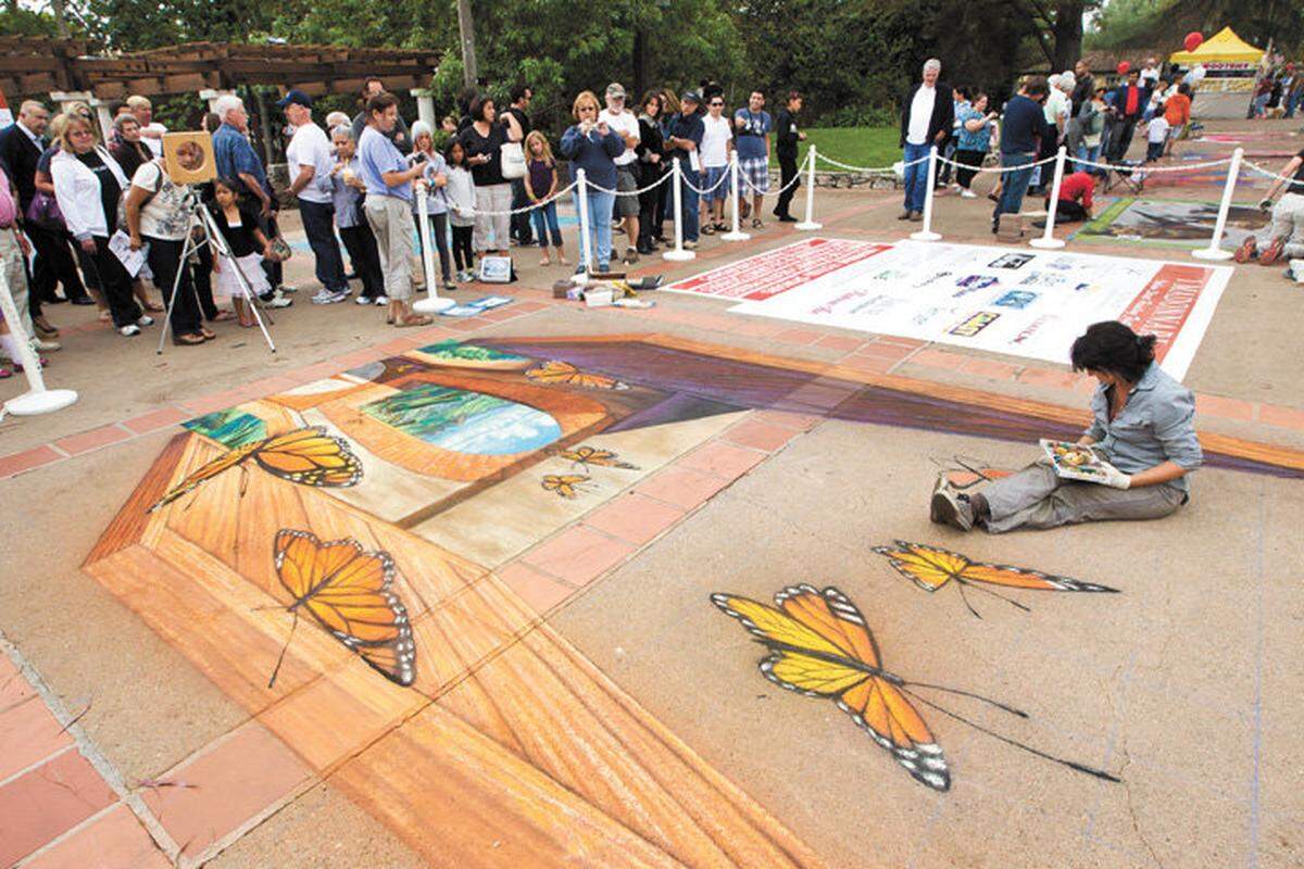Tracy Lee Strum from Santa Barbara works on her 3D chalk painting.