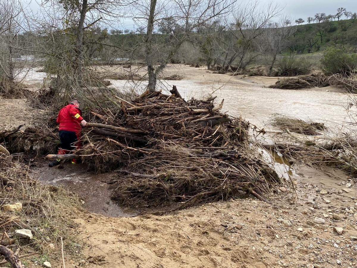 Searchers check through floodwaters and debris for any sign of 5-year-old Kyle Doan on Wednesday, Jan. 11, 2023, two days after he disappeared in swollen San Marcos Creek near San Miguel.