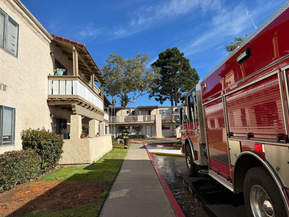 Jubriel Arnsey waits outside after his apartment building in Arroyo Grande caught fire on Thursday, Jan. 25, 2024.