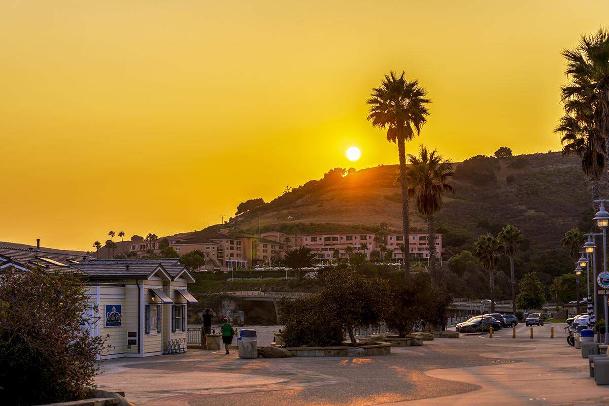 The sun sets over Front Street in Avila Beach.