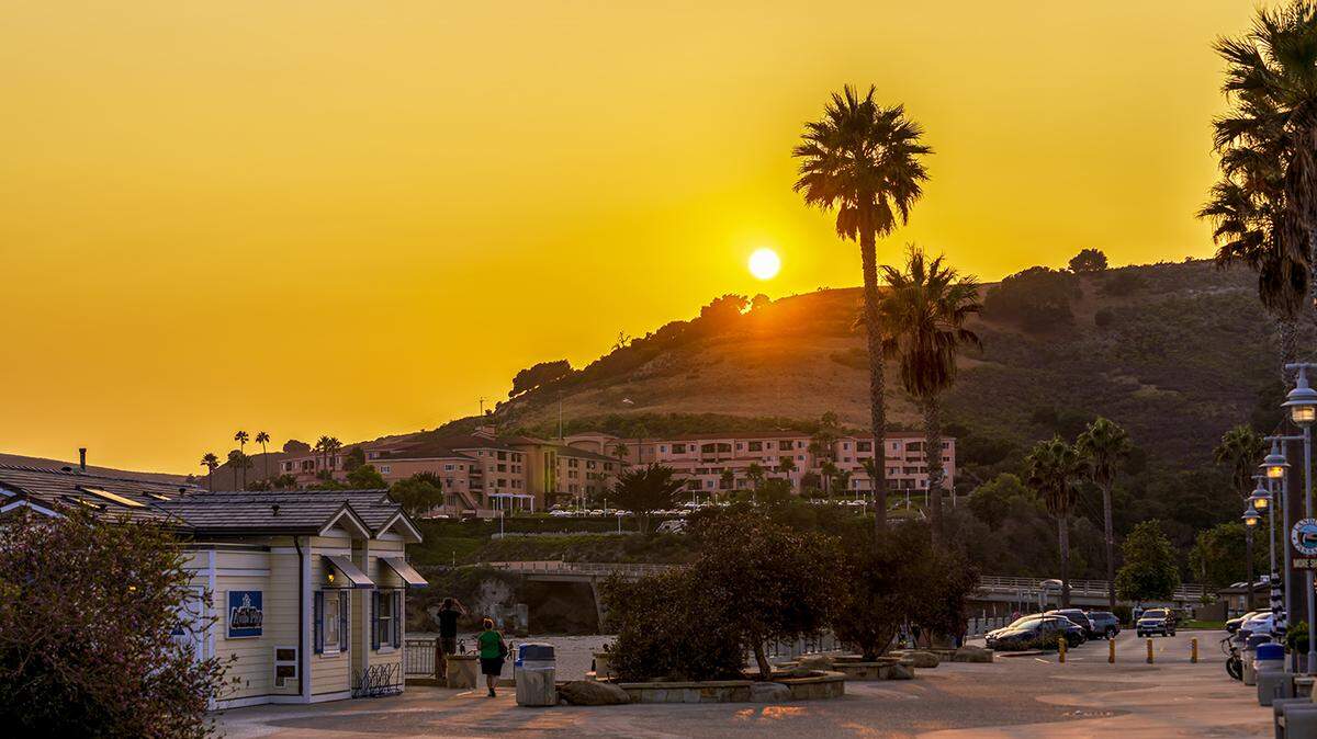 The sun sets over Front Street in Avila Beach.