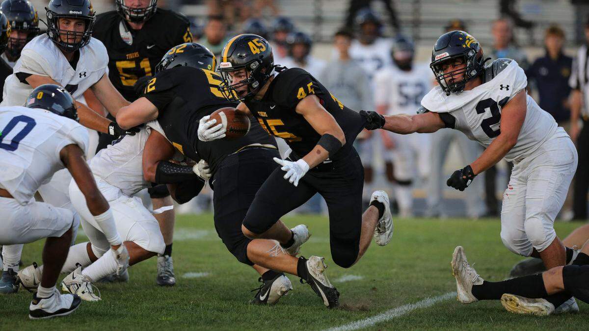 Colbin Garrison is slowed by a shirt grab by 21 Rocco Koory, allowing Caleb Clark to come in from left to tackle. Arroyo Grande beat San Luis Obispo 23-0 in a high school football game on Sept. 6, 2024.