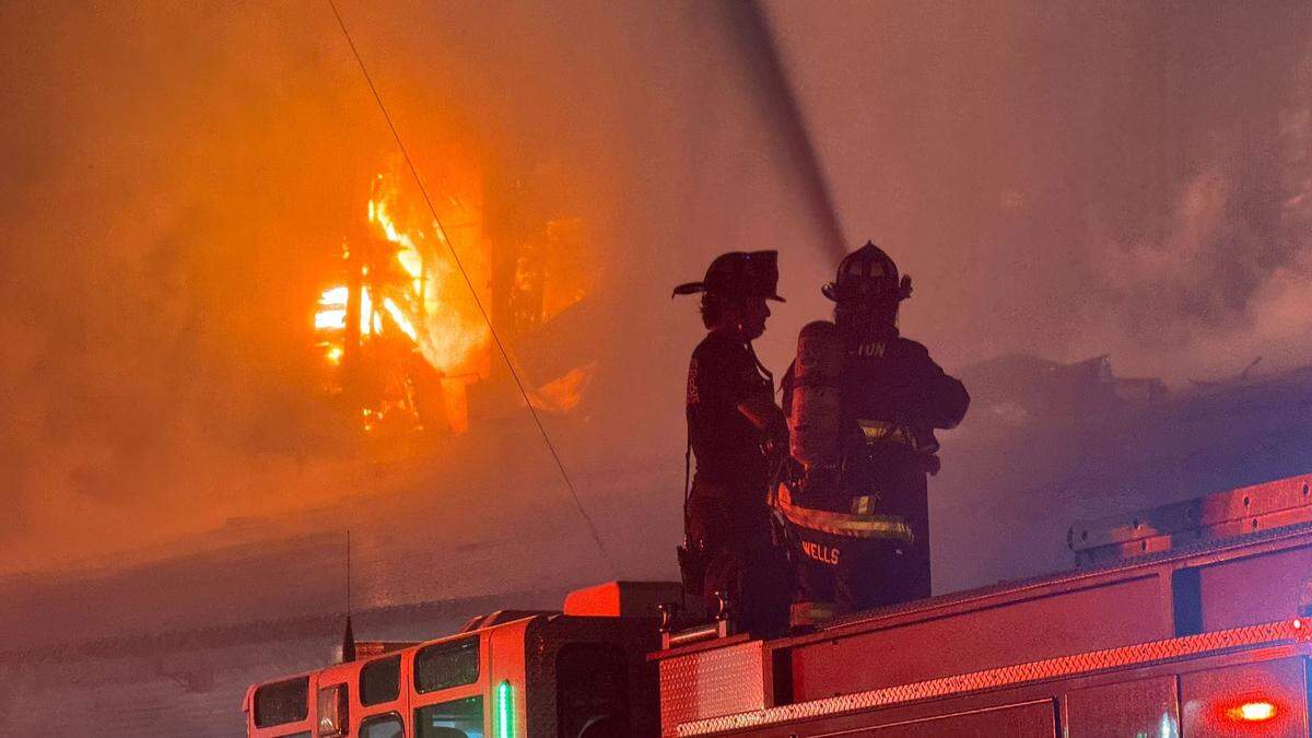 Flames could be seen erupting from the upper floor and roof area of Templeton Feed & Grain early July 5, 2025, as firefighters attempted to save the building.&nbsp;