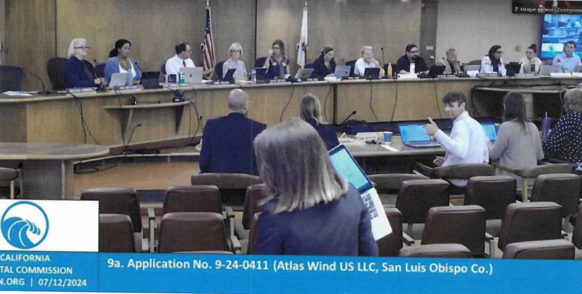 California Coastal Commission deputy director Cassidy Teufel flashed a thumbs up at the audience after the commission granted a permit to Atlas Wind to conduct site surveys in state waters.