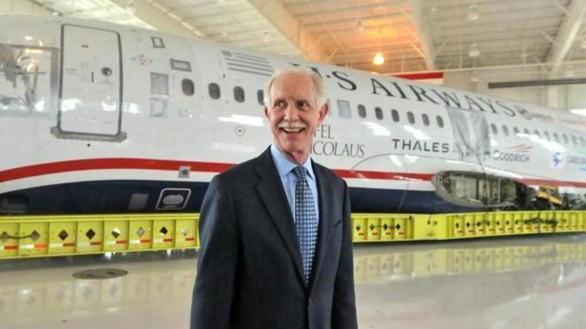 Capt. Chesley Sullenberger stands in front of the US Airways flight 1549 fuselage at the Carolinas Aviation Museum on Saturday, June 11, 2011.