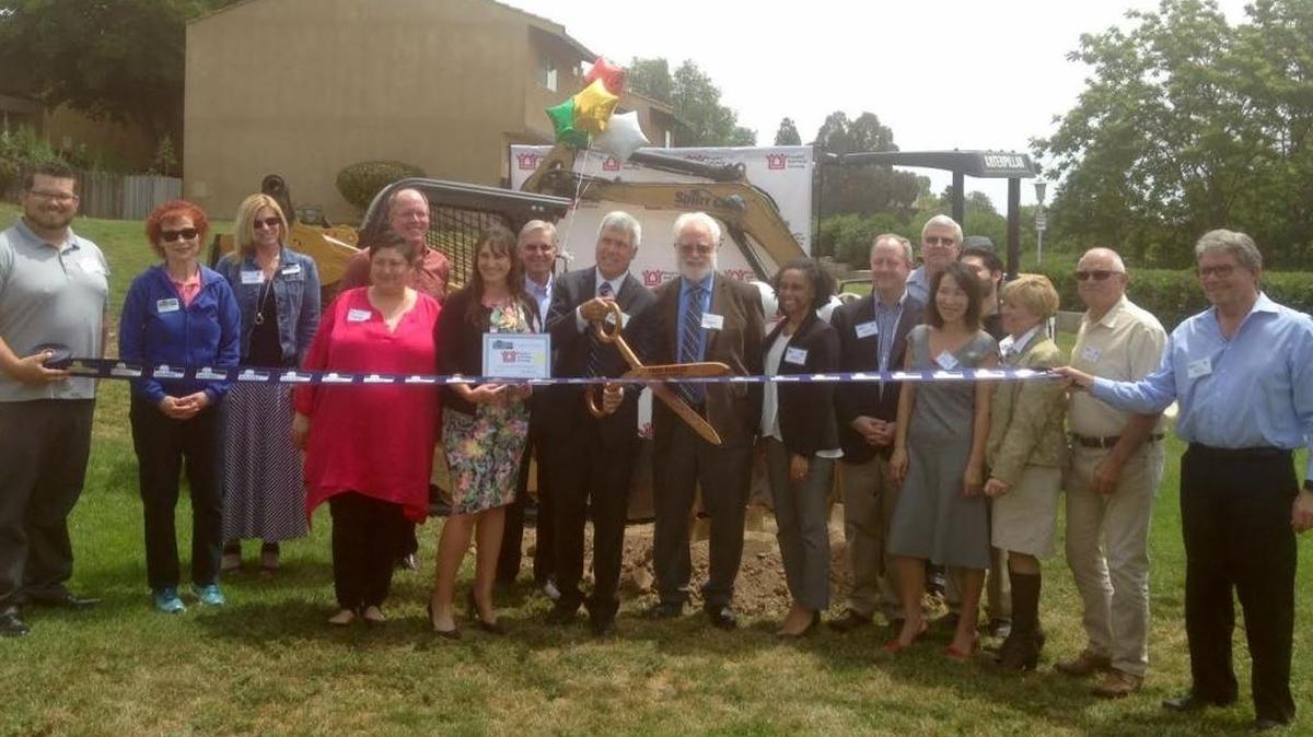 John Fowler, Peoples’ Self-Help Housing CEO, cuts the ribbon on the Creston Garden remodel project alongside other stakeholders and state, local and federal officials. The affordable housing complex is set to undergo $14 million in renovations.