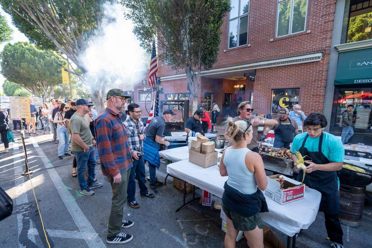 People line up to get food at the F. McLintocks barbecue at Farmers Market in San Luis Obispo.