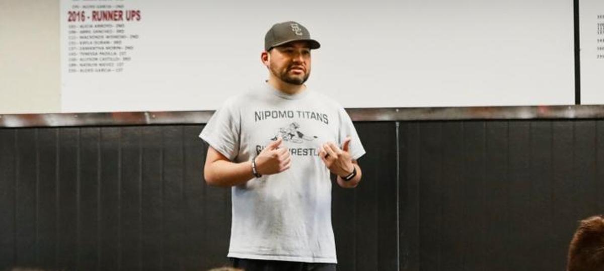 Former Nipomo High School girls wrestling coach Justin Magdaleno talks to his team at the end of a practice in January 2017.