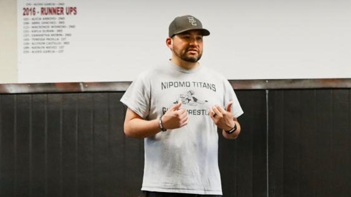Former Nipomo High School girls wrestling coach Justin Magdaleno talks to his team at the end of a practice in January 2017.