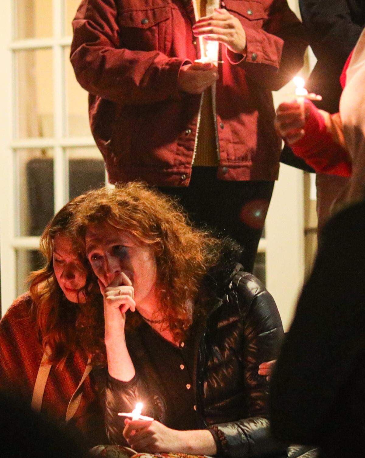 Sol Valdes, left, and Lola White-Sanborn listen to others speak before each later took a moment to share their thoughts, during a community vigil in front of the Gala Pride and Diversity Center in San Luis Obispo on Nov. 21, 2022. The San Luis Obispo gathering was in response to a shooting that killed 5 people and injured several others at an LGBTQIA club in Colorado Springs. This photo won first place for best news photo in the 2022 California Journalism awards.