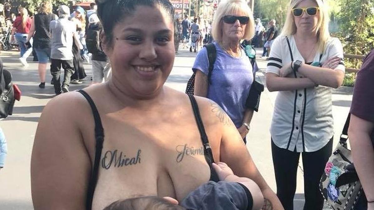 Brittni Medina poses while breastfeeding her 10-month-old son in line at Disneyland. She says the two women in the background were making snarky comments about her.