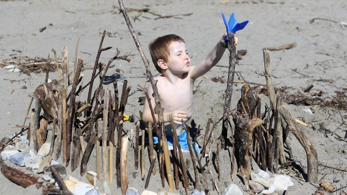 After days of rain, blue skies and sunshine brought people out to Avila Beach on Sunday. James Streeper, 5 of Arroyo Grande plays in a fort he found, according to mom Christie Streeper.