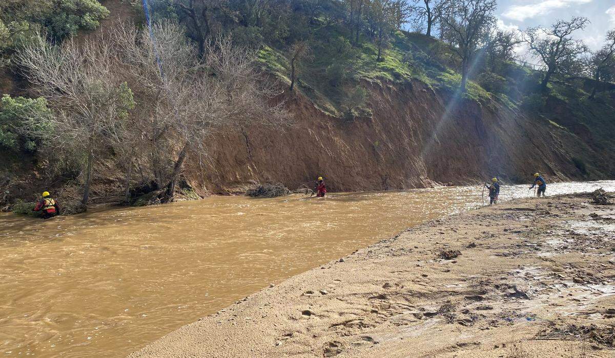 Members of the San Luis Obispo County sheriff’s search-and-rescue team look for 5-year-old Kyle Doan near San Miguel on Tuesday, Jan. 10, 2023. The boy was swept away by floodwaters on Monday.