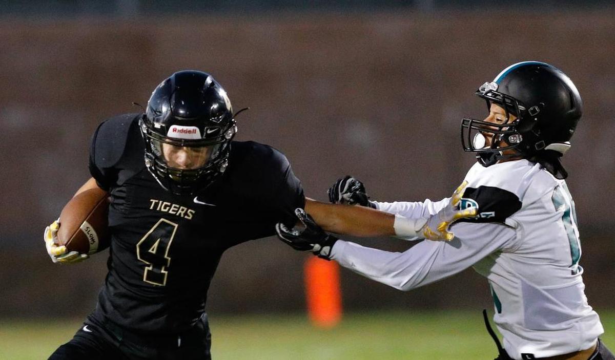 San Luis Obispo High School running back Anthony Arroyo carries the ball as Pioneer Valley’s Edwin Romero makes the tackle in an Ocean League football game Friday night.