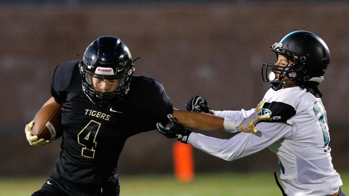 San Luis Obispo High School running back Anthony Arroyo carries the ball as Pioneer Valley’s Edwin Romero makes the tackle in an Ocean League football game Friday night.
