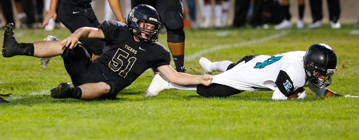 San Luis Obispo High School’s Kevin Jess makes a shirt tackle of Daniel Vasquez of Pioneer Valley in an Ocean League football game Friday night.