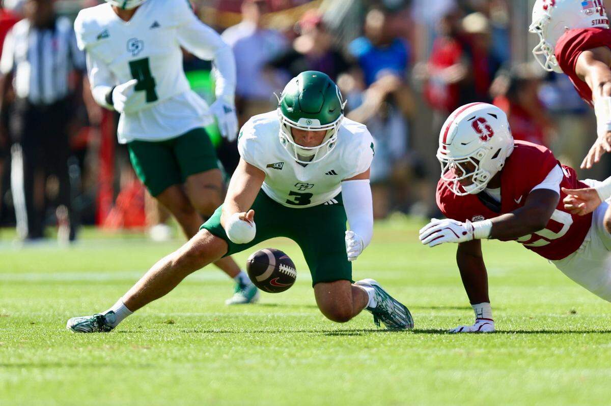 Ethan Calvert scoops up a fumble in Cal Poly’s 41-7 loss to Stanford in a college football game on Sept. 7, 2024.