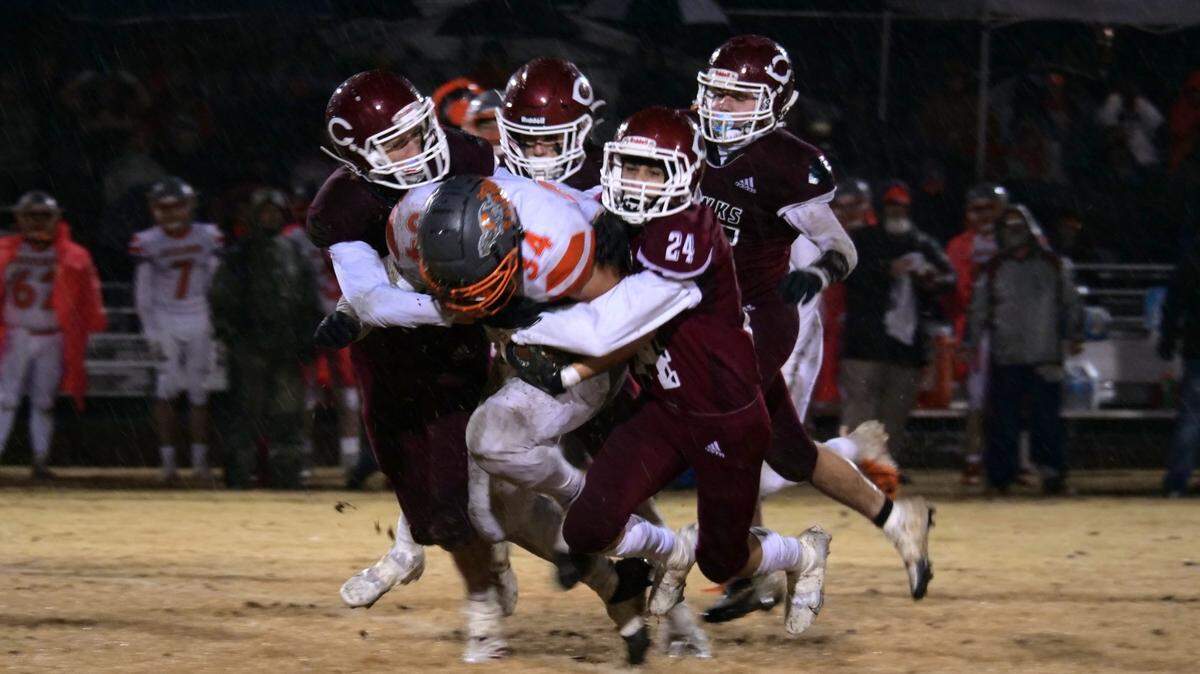 Atascadero’s Trey Cooks pushes for extra yardage as a trio of Redhawks defenders try to bring him down. Atascadero beat Colusa 21-0 on Dec. 2, 2022, in the CIF Division 6-A Regional Final to advance to the state championship game.