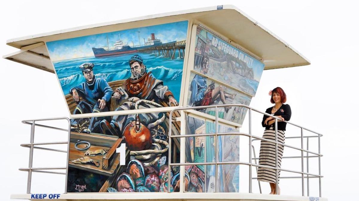 Artist Colleen Gnos, painted two murals which grace two 12-foot-tall lifeguard towers stationed in the sand on either side of the Avila Beach Pier.
Photo by Joe Johnston 06-25-18