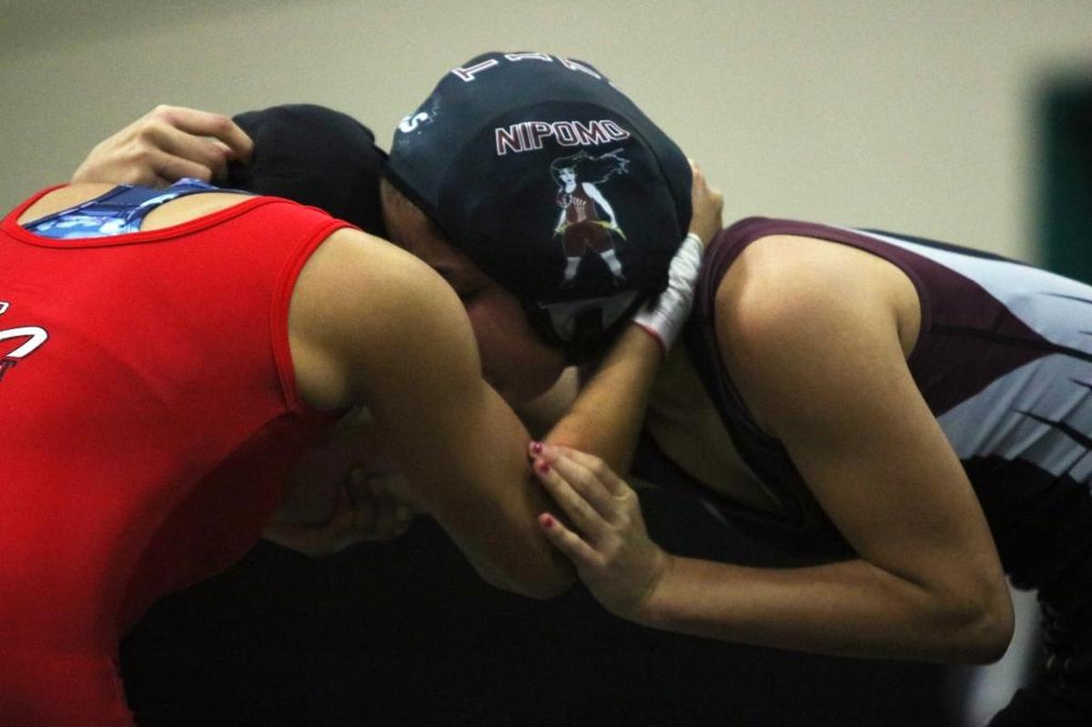 A Nipomo High School female wrestler grapples with an opponent from Santa Maria High at the CCGWA League Duals at Pioneer Valley High School on Jan. 11.