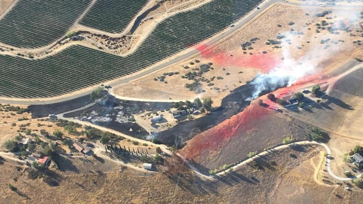 Firefighters fight the Ridge Fire Sunday evening in Hog Canyon in the San Miguel area.