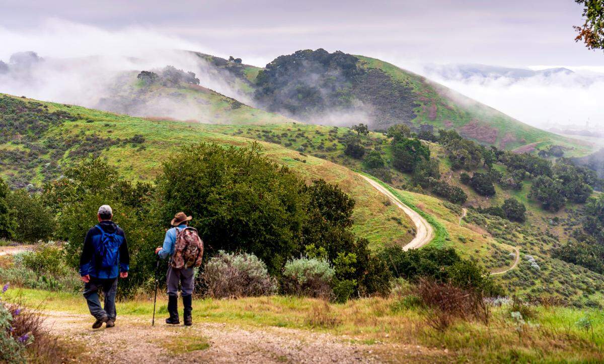 Hikers walk in the hills above Pismo Beach.