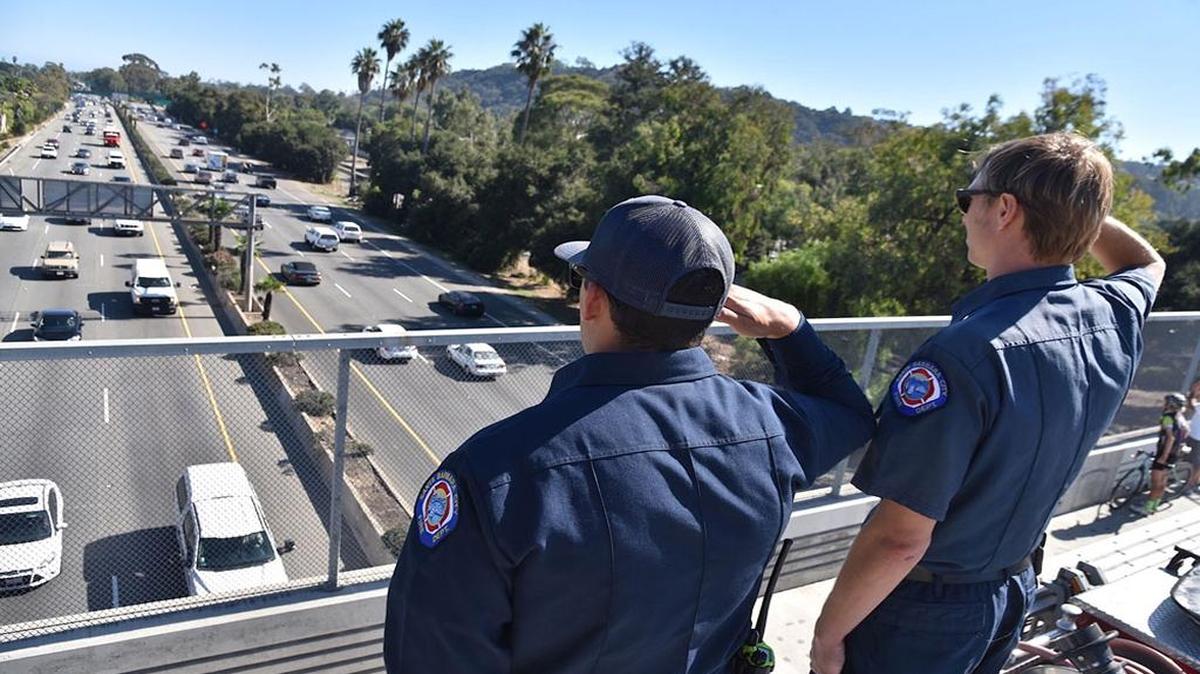 Two Santa Barbara city firefighters salute Saturday, October 7, 2017 as the body of Derrick “Bo” Taylor, who was killed in the Las Vegas massacre, is transported up Highway 101 to a Grover Beach funeral home.