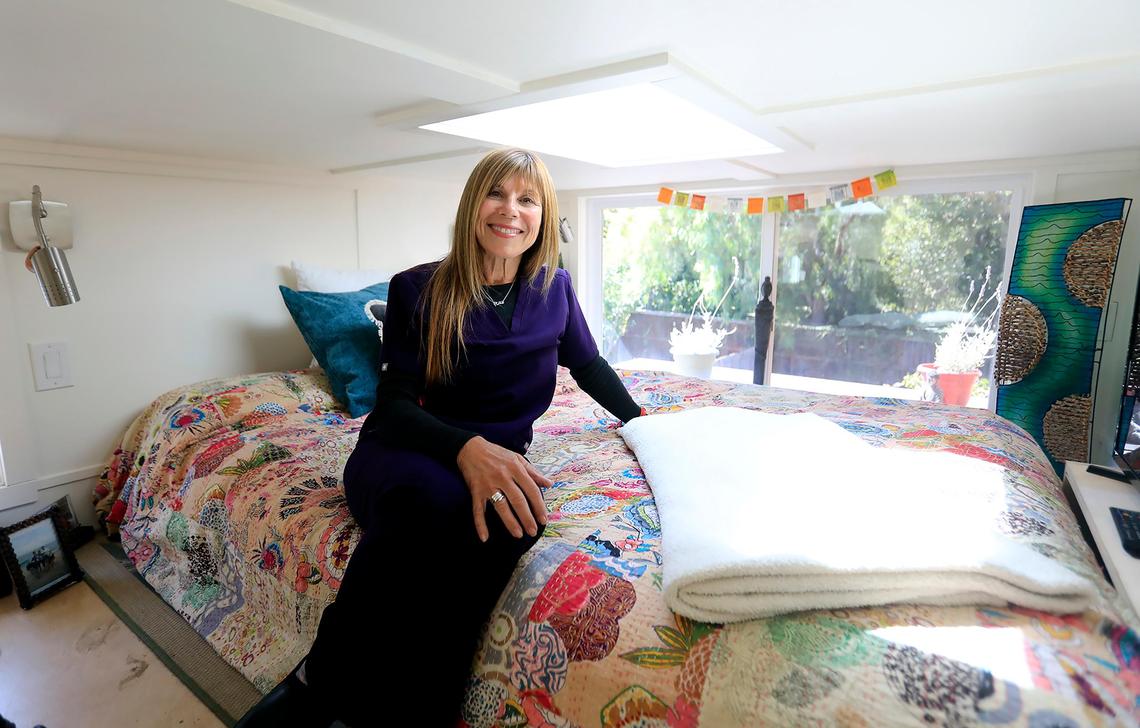Tiny homes are now allowed in San Luis Obispo and some locals are building and living in them. Rita Morris lives in a tiny home in a San Luis Obispo back yard. Morris is pictured in her sun-washed loft bedroom.
