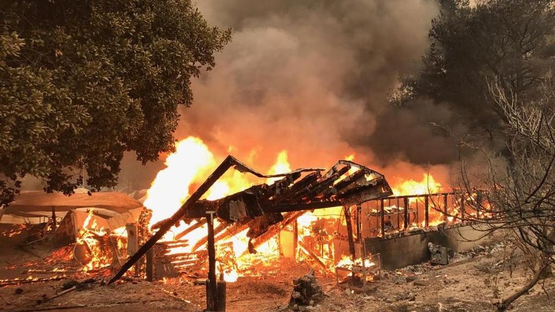 Rancho Alegre Outdoor School buildings burn Saturday as the Whittier Fire rages along the Highway 154 corridor.