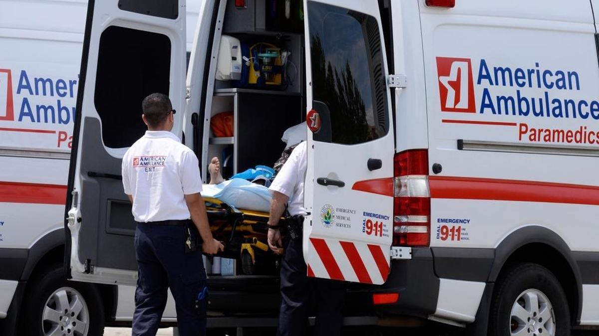 EMTs unload a patient.