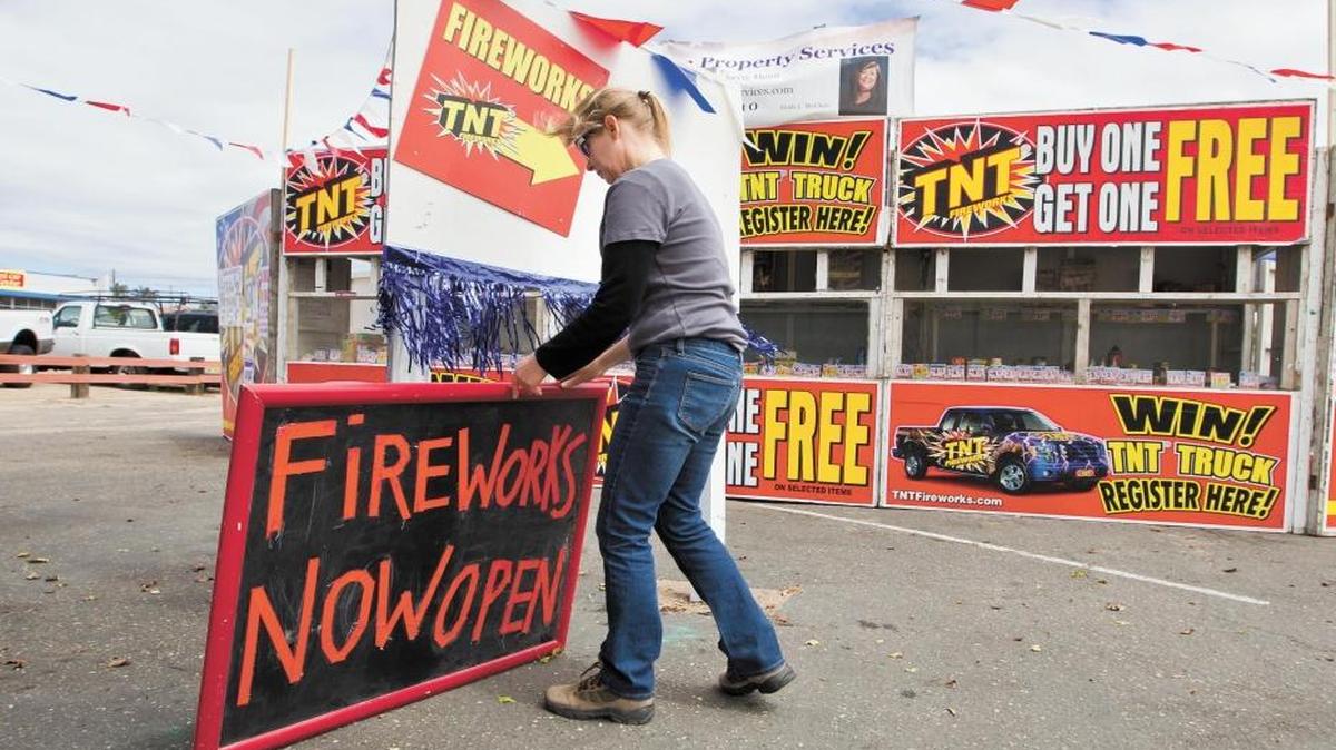 Linda Garcia puts up a sign at a fireworks stand in Grover Beach in 2011. "Safe and sane" fireworks can be purchased in parts of San Luis Obispo County through July 4, 2018.