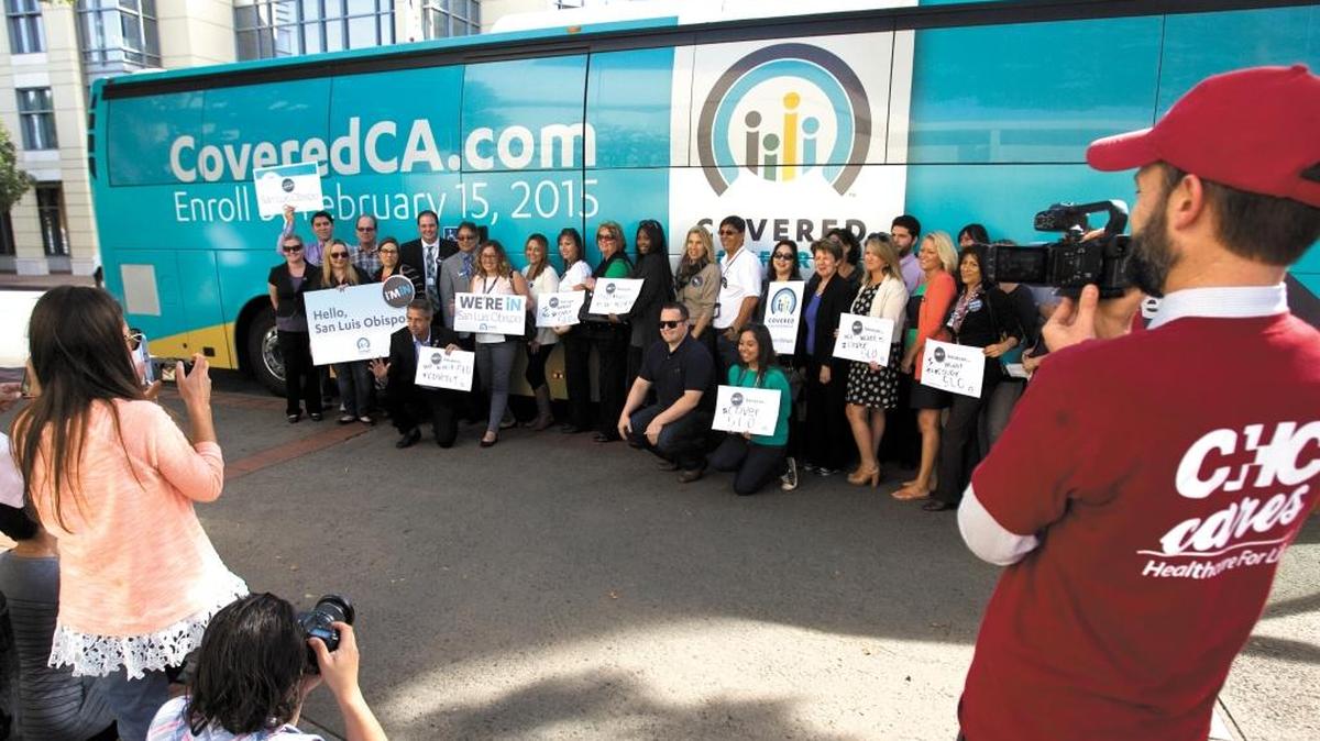Covered California Executive Director Peter V. Lee will be in Templeton on Wednesday to promote health insurance sign-ups for 2016. The Covered California tour bus, with Lee kneeling on the left, was in San Luis Obispo on Nov. 17, 2014.