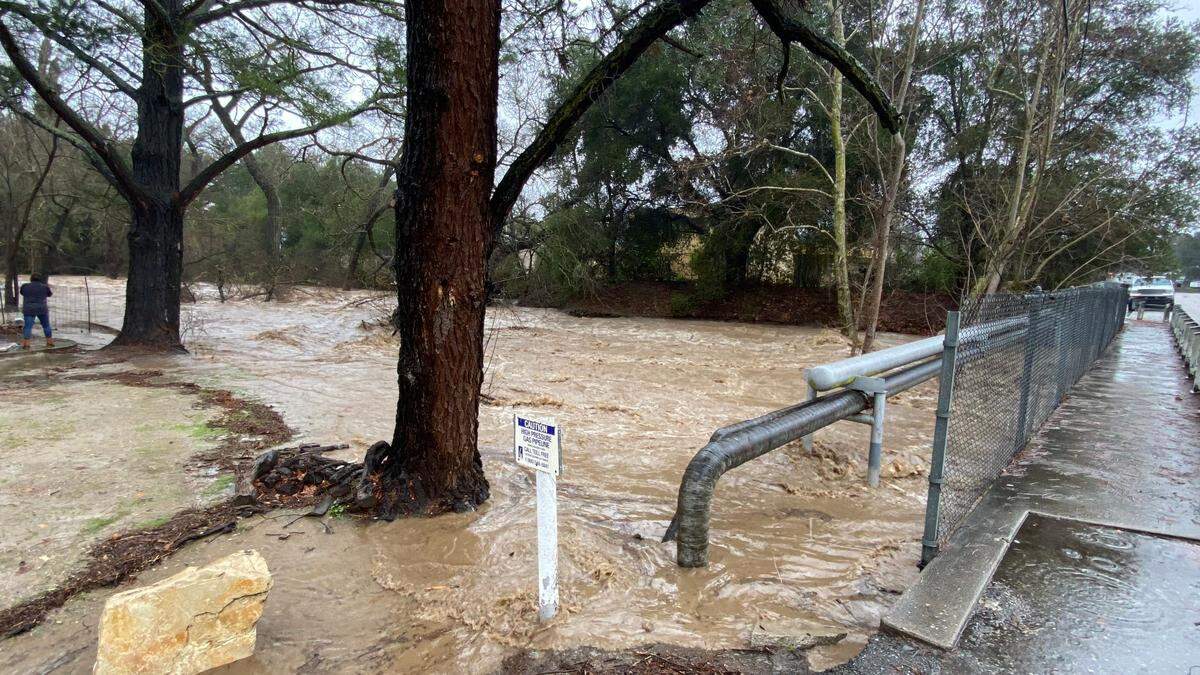 Atascadero Creek runs right to the level of the bridge near Atascadero High School and North County Christian School on Jan. 9, 2023.