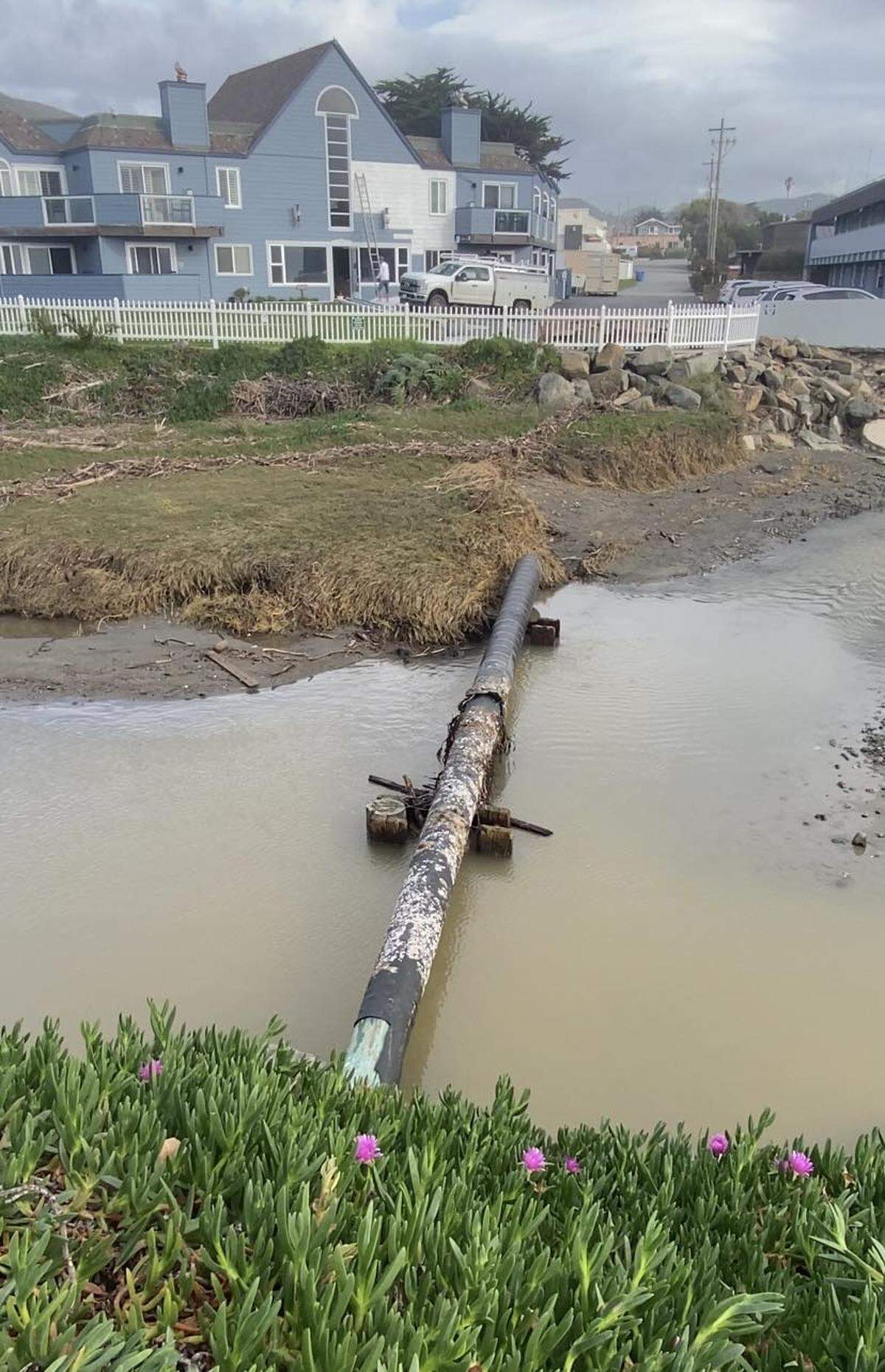 A broken piling from the Cayucos Pier rests in the creek adjacent to Shoreline Inn on Feb. 20, 2024.