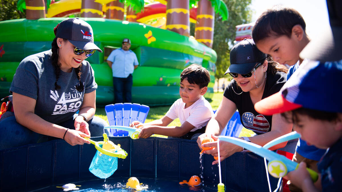 Kids play at the Family Fun Zone during Fourth of July festivities at Barney Schwartz Park in Paso Robles on July 4, 2023. The San Luis Obispo metropolitan area is one of the most expensive places in the United States to raise a child, according to SmartAsset.