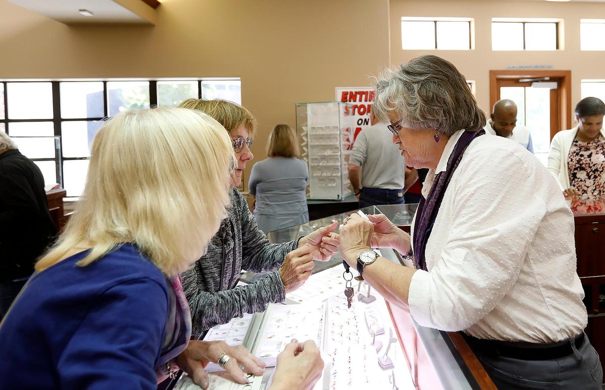 K. Jons employee Leigh Livick, right, shows pieces of jewelry to Carol Kiessig of Paso Robles and Lorene Cabrera of San Luis Obispo. The store’s owners are retiring and having a liquidation sale to sell off the store’s entire inventory.