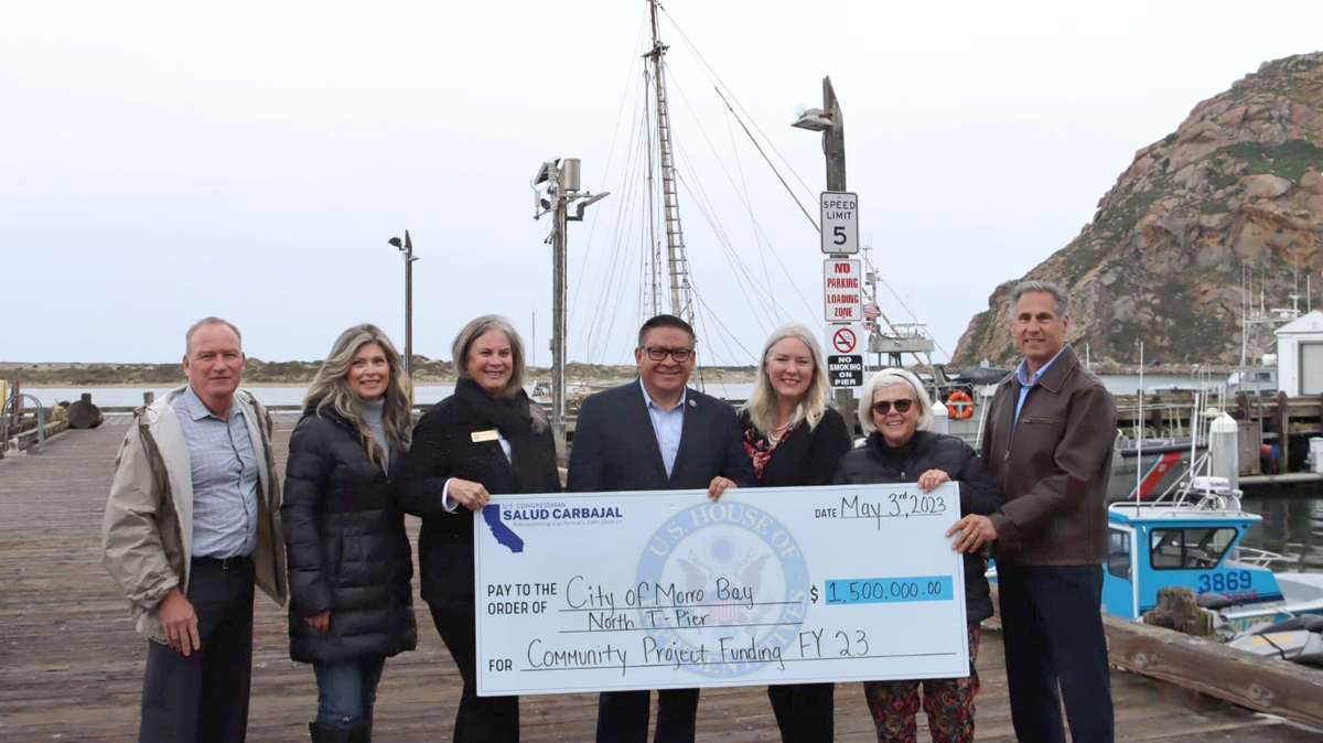 From left, Morro Bay Interim City Manager Greg Carpenter, Councilmember Cyndee Edwards, Mayor Carla Wixom, Congressman Salud Carbajal, Mayor Pro Tem Jennifer Ford, Councilmember Laurel Barton, and Harbor Director Ted Schiafone celebrate $1.5 million in funding for the North T-Pier on Wednesday, May 3, 2023.