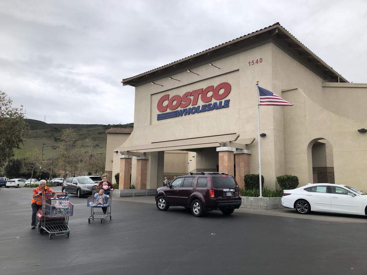 Costco shoppers leave the San Luis Obispo store in 2020. The popular warehouse retailer is changing its hours for Executive members.