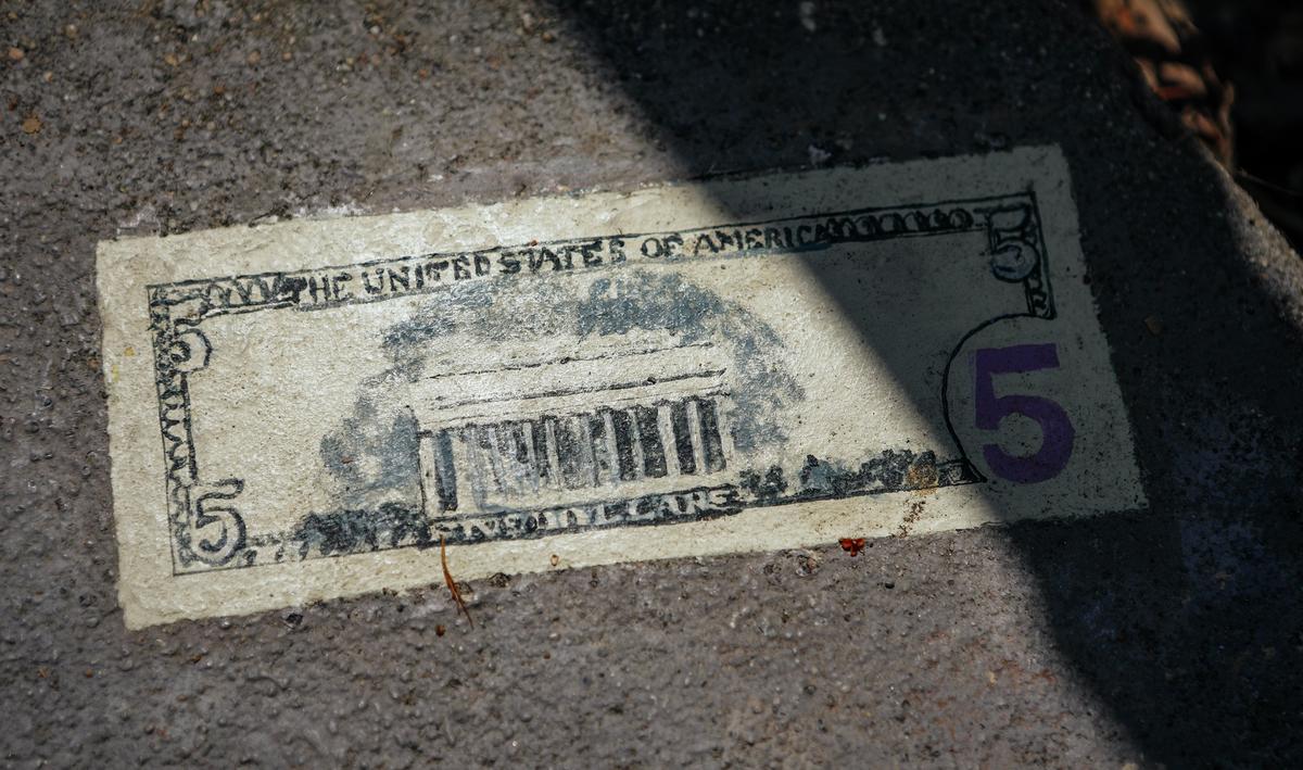The $5 bill Christine painted on the sidewalk outside her home as a whimsical trick on passers-by.