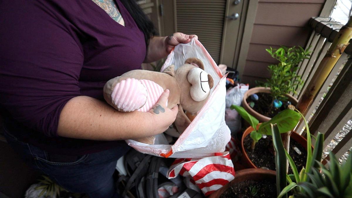 Monika Saenz runs a facebook group that helps North County people, seated behind her is her husband David. Her porch has donations waiting to be picked up. David Middlecamp 12-23-2019