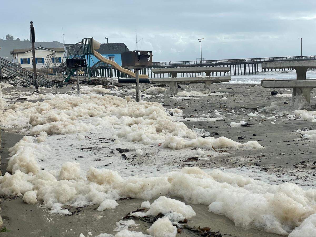 Piles of sea foam collect on the sand in Avila beach on Thursday, Jan. 5, 2023, after a powerful “bomb cyclone” storm him San Luis Obispo County.