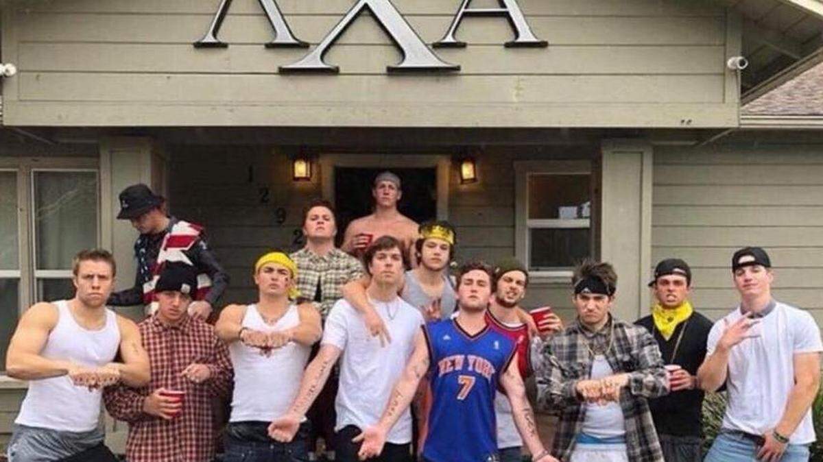 Members of Lambda Chi Alpha are shown dressing as gangster stereotypes and throwing gang signs in front of their fraternity house. The photo was taken Saturday and the Instagram account it's from has been deleted.