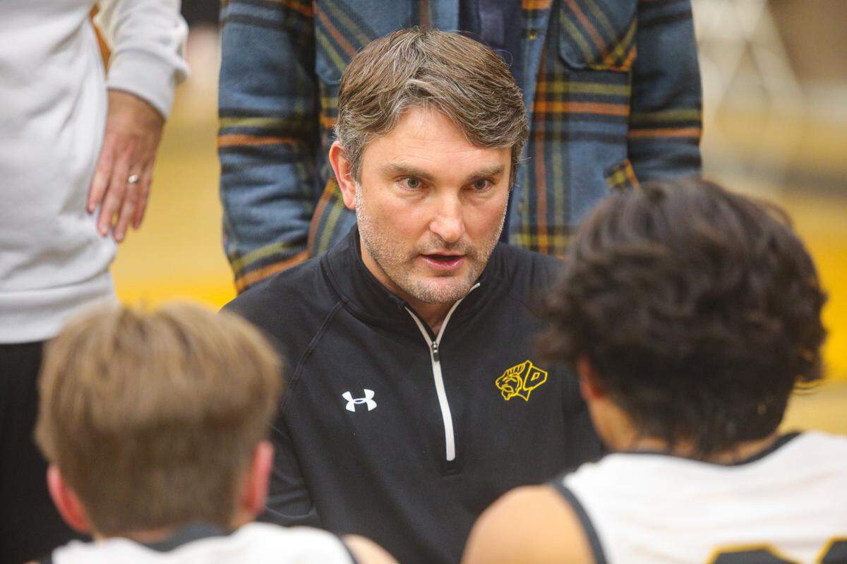 San Luis Obispo High School boys basketball Coach Jeff Brandow talks to the team during a game on Jan. 20, 2023.