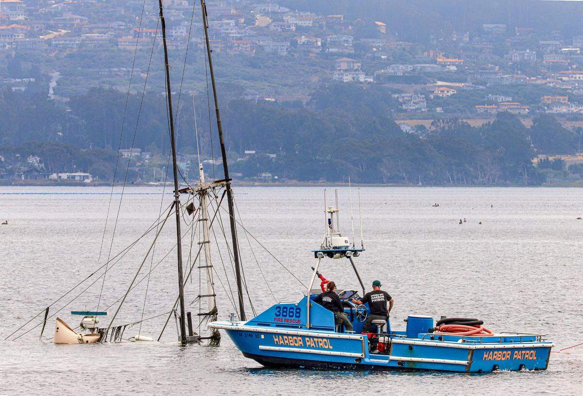 The fishing boat Lady Maxine is seen partially submerged in the Morro Bay Harbor.