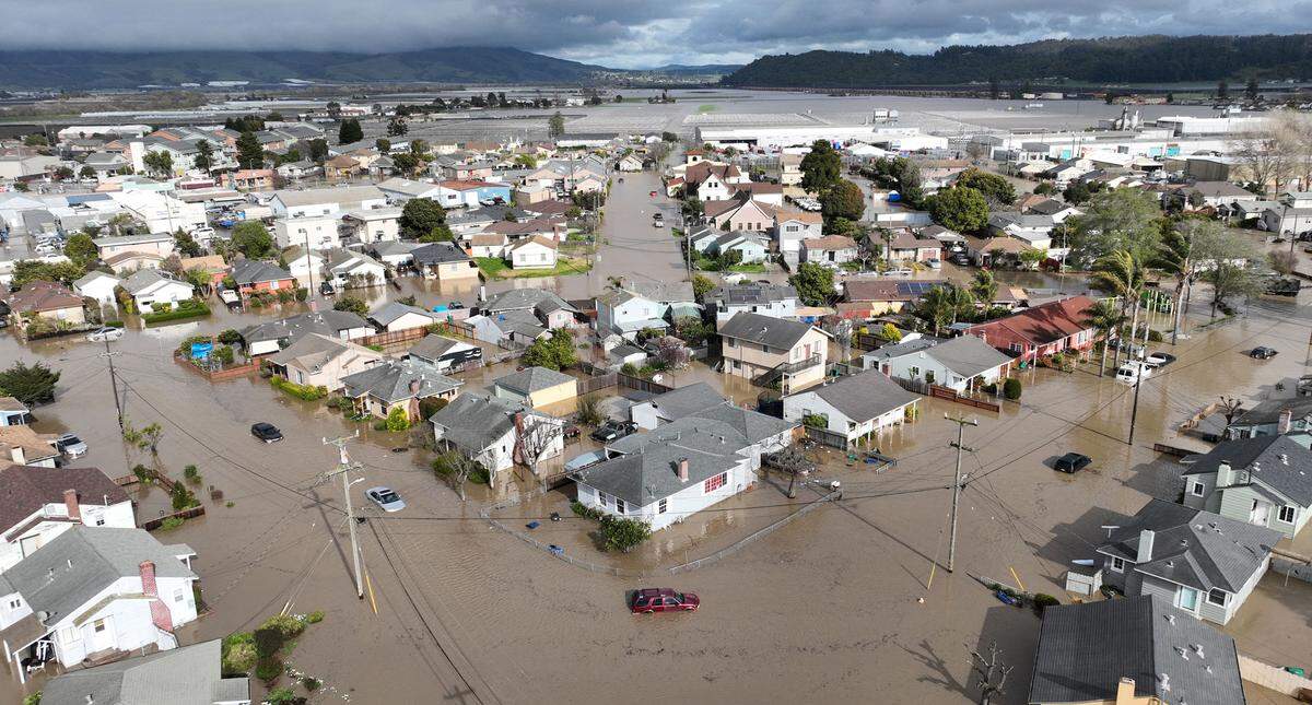 Vehicles and homes engulfed by floodwaters in Pajaro, California on Saturday, March 11, 2023.