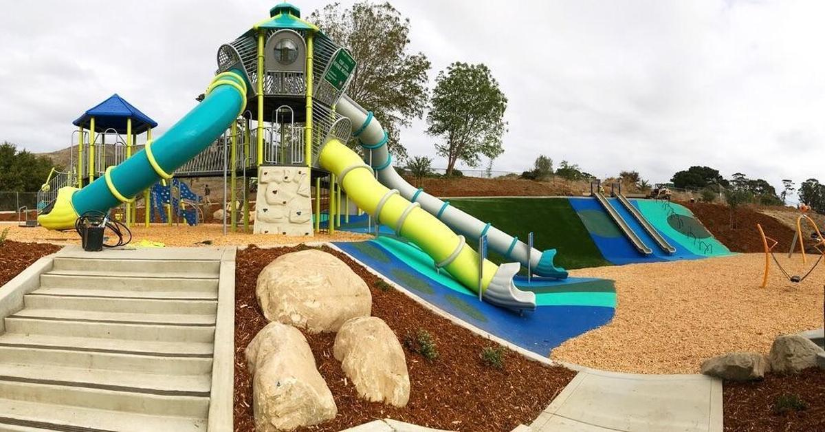 The Sinsheimer Park playground features a climbing structure that resembles a space robot in front of an artificial grass hill where kids can slide on pieces of cardboard. The city is taking comments from the public on what it would like to see for its parks, facilities and recreation.