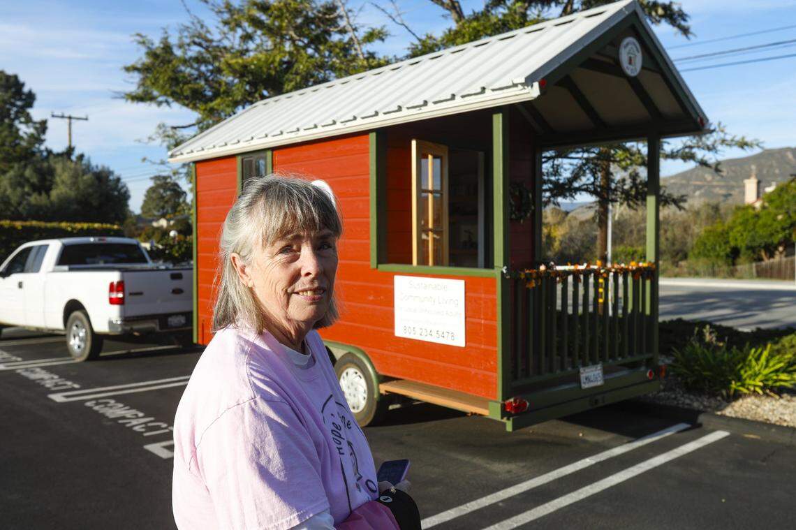 Becky Jorgeson, the president of Hope's Village, an advocate for tiny homes like the one shown behind her.
